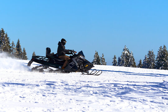 Snowmobile Polaris Titan 800. Vehicle for universal use under extreme operating conditions.Winter in black forest. Driving on the ski slope. Feldberg, Germany.