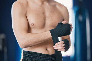 Sports, boxing and man wrap hands in gym for training, workout and exercise for mma fight. Fitness, body builder and male athlete with bandage prepare for boxer competition, practice and performance