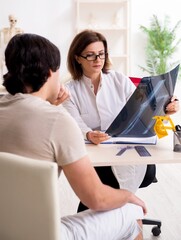 Female doctor checking patient's joint flexibility with goniomet