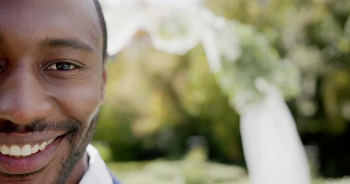 Portrait of happy african american groom smiling at wedding in sunny garden, copy space, slow motion