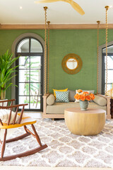 Reception space or living room of a big house in cottage style. Living room with green wall and plant and green wall.