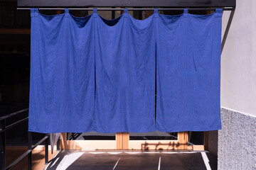 The curtain-like fabric that hangs in front of traditional Japanese restaurants and shops not only serves as a signboard, but holds a larger meaning,