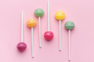 Sweet lollipops on pink background