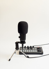 Selective focus shot of condenser microphone and audio interface isolated on white background. The...
