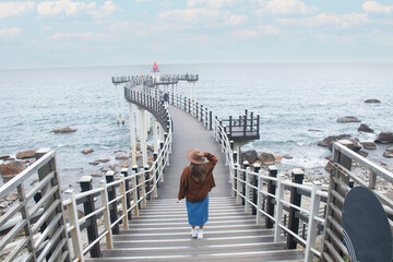 Woman traveller is sightseeing at Igari Anchor Observatory with the background of waves and sea horizon.