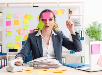 Young female employee in conflicting priorities concept