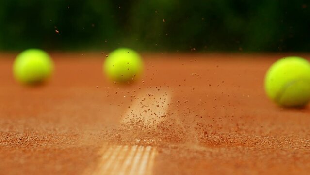 Super slow motion of Tennis ball ping on clay court inside or outside white line. Filmed on high speed cinematic camera at 1000 fps.