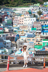 Woman traveller is sightseeing and looking at Gamcheon Culture Village in Busan, South Korea.