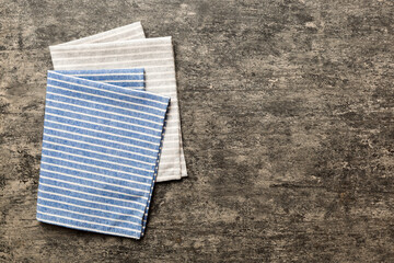 top view with blue kitchen napkin isolated on table background. Folded cloth for mockup with copy space, Flat lay. Minimal style - obrazy, fototapety, plakaty