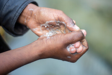 A man is washing his hands with soap