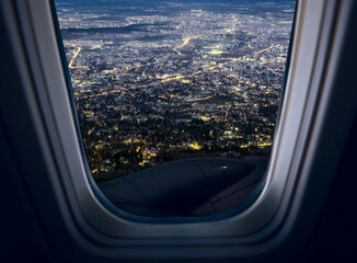 The capital of Bulgaria is Sofia. View of the city at night through the porthole.
