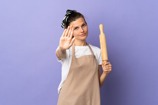 Cooker Slovak woman isolated on purple background making stop gesture