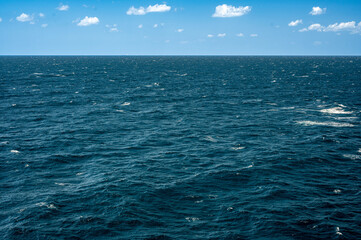 Obraz premium Ocean, sea, background and texture. Blue water background. Ripple sea ocean water surface. ocean water surface. close up blue water surface at deep ocean. Dark blue background