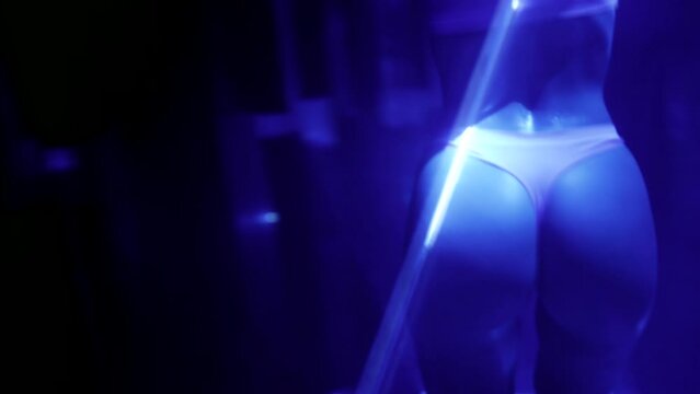 ideal female body, closeup of butt and legs during erotic dance show in strip club, go-go dancer