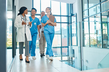 Healthcare, doctors and nurses walking together for discussion, planning or schedule. Diversity,...