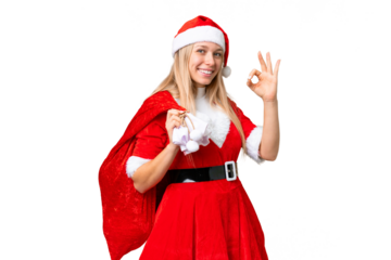Young blonde woman with christmas hat over isolated chroma key background showing ok sign with fingers