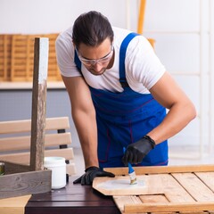 Young male contractor working in workshop