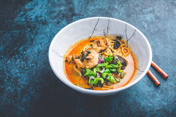 Thai red curry soup with chicken, shiitake mushrooms, coconut milk and green onions