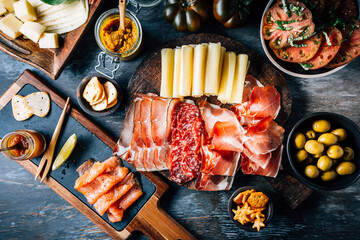 Appetizers with different antipasti, charcuterie, snacks, meat platter with cheese and spicy olives