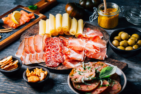 Appetizers with different antipasti, charcuterie, snacks, meat platter with cheese and spicy olives