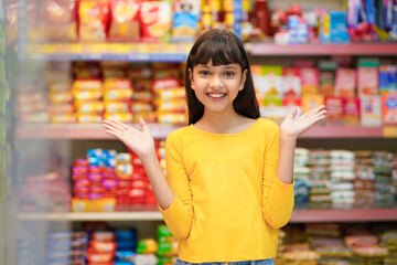 Indian girl purchasing at grocery shop