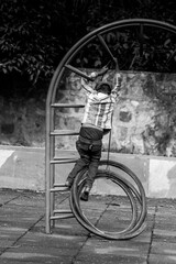 series shots of a poor boy who was having fun and playing with cycle tyre in the park