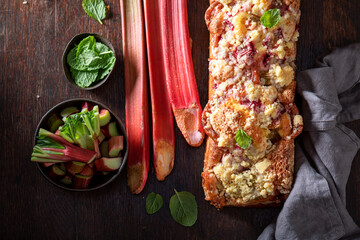 Sweet and sour rhubarb yeast cake served as summer dessert.