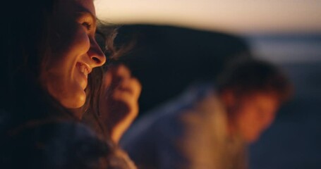 Happy, talking and a woman at a beach bonfire for conversation, holiday and summer happiness. Smile, laughing and a young girl at the ocean with a campfire and friends for the sunset and vacation - Powered by Adobe