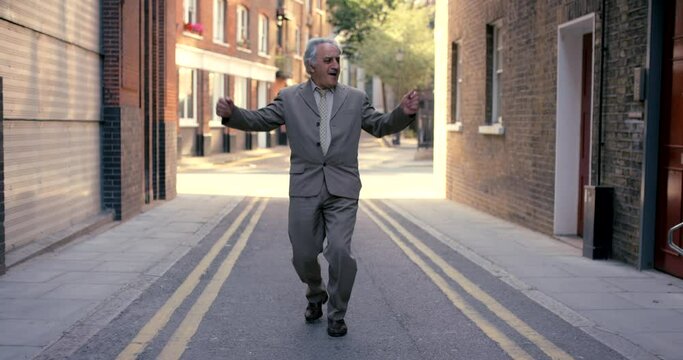 Senior businessman, dance and street in city with happiness, music or celebration with steps. Elderly business man, suit and excited executive for dancing, moving or freedom with energy in metro road