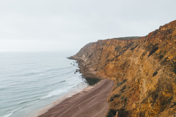 Mountainous coastline of Portugal's southern peninsula in the famous tourist region of the Algarve. The rocky cliffs around the town of Luz. Discovering the Fisherman trail, Rota Vicentina