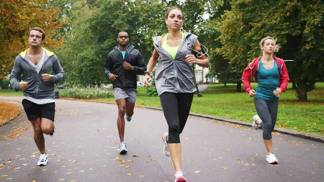 Fitness friends, running in park and cardio with health and wellness, men and women run together in exercise club. People, runner and training for race, solidarity and motivation for workout outdoor