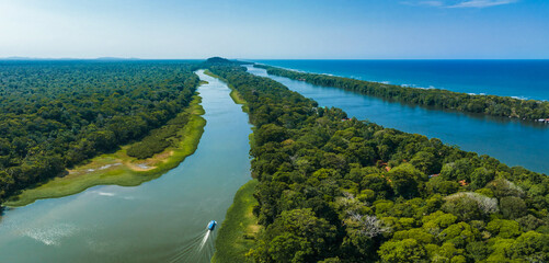 Caribbean sea on the one side, village Tortuguero inside the jungle in the middle, and huge river...