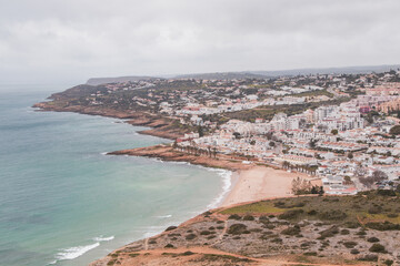View of the city of Luz and the Atlantic Ocean beaches from the top of Atalaia hill in the Algarve region of southern Portugal. Following in the footsteps of the Fisherman Trail. Rota Vicentina