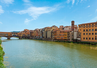 Medieval stone closed-spandrel segmental arch bridge Ponte Vecchio over Arno river in Florence, the capital city of Tuscany region, Italy. People unrecognizable.