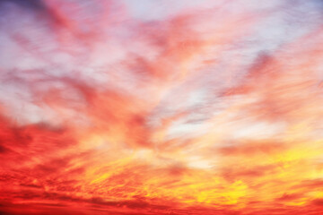 Bright orange and pink sunset sky with many clouds. Dramatic and moody nature backgrounds
