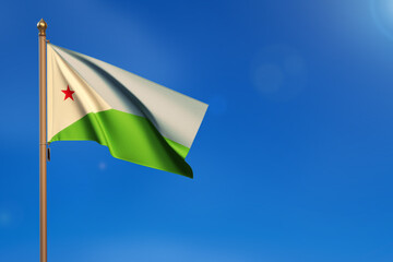 Djibouti. Flag blown by the wind with blue sky in the background.