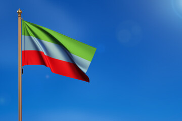 Dagestan. Flag blown by the wind with blue sky in the background.