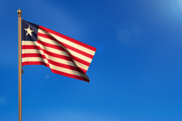 Liberia. Flag blown by the wind with blue sky in the background.
