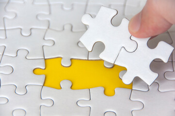 Hand holding separated jigsaw puzzle with customizable space for text. Copy space.
