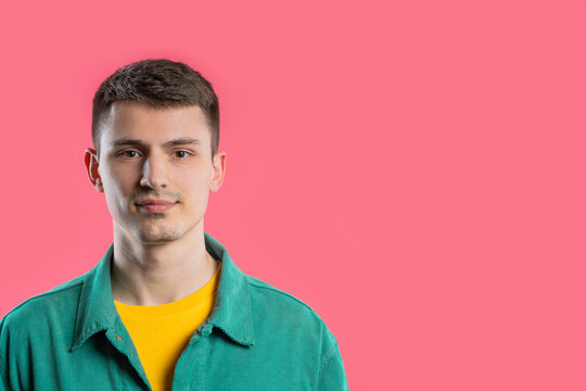 Portrait Of Stylish Young Man In Colorful Outfit. Handsome Guy On Pink Studio