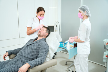 Middle-aged patient undergoing a scalp plasmolifting procedure