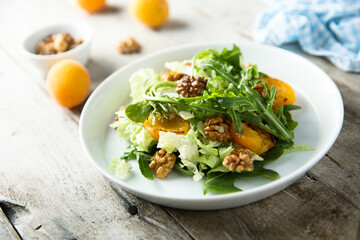 Healthy leaf salad with apricot and walnut