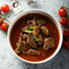 Homemade beef goulash with fresh basil