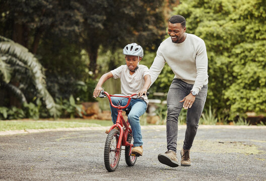 Black Family, Father Teaching Child Cycling In Park With Bicycle And Helmet For Safety, Learning And Help. Support, Motivation And Trust, Man With Boy Outdoor And Learn Bike Riding With Mockup Space