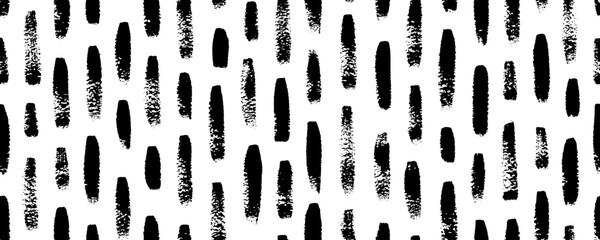 Vertical brush strokes seamless pattern. Black and white organic texture with scribble brush marks. Rain abstract seamless banner. Geometric ornament with vertical dashes, drops or short stripes.