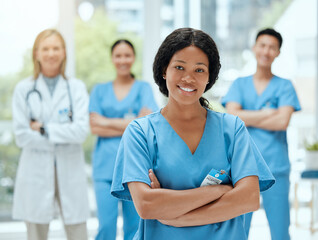 Portrait, medicine and a black woman nurse arms crossed, standing with her team in a hospital for...