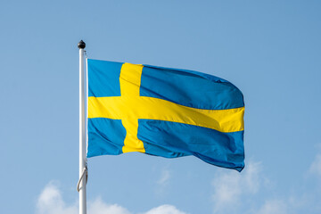 Swedish Flag Day. Swedish Flag on Blue Sky Backdrop. The National Day of Sweden- Swedish Flag. Celebration of Swedish Flag.