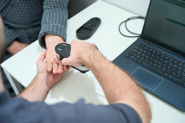 Specialist put an apparatus for rapid screening to patients hand