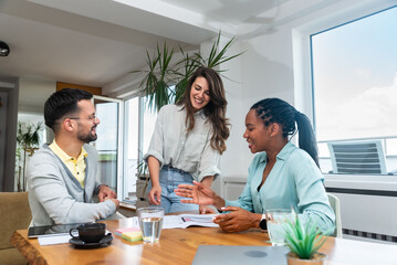 Business professionals. Group of young confident business people analyzing data using computer while spending time in the office. Workers working on new project, teamwork success as experts.