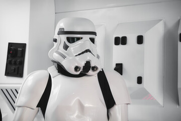 Naklejka premium 20 May 2023, St. Julians - Malta: A stormtrooper from the Star Wars movie in full body armor suit costume standing in a spaceship background setting